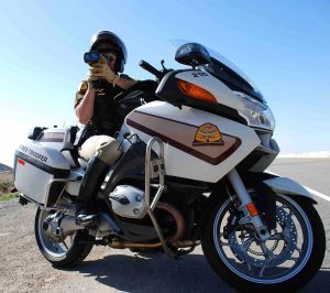 A UHP motor officer aims a lidar detector at oncoming traffic