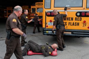 Troopers inspect a school bus for safety certification - photo from Herald Extra