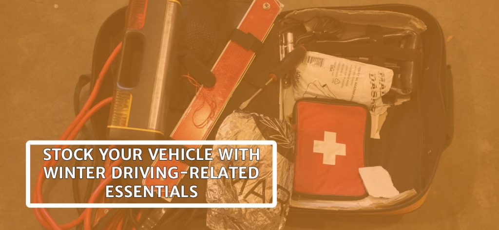 An open vehicle emergency kit has a flashlight and tools and cables and text reads stock your vehicle with winter driving related essentials.