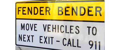 Picture shows road sign that read Fender Bender move vehicles to next exit call 911
