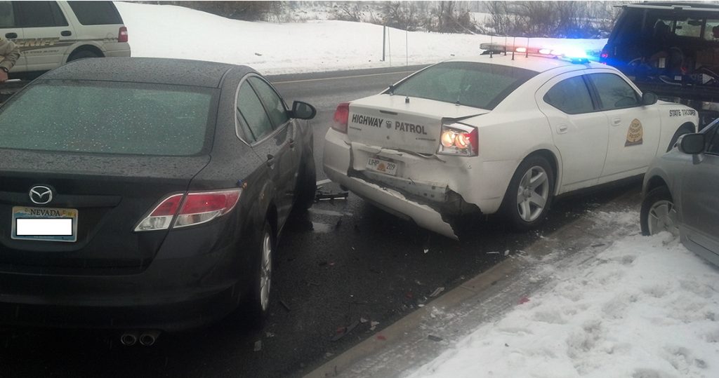 A UHP car and two others are on the shoulder and one car has crashed into the UHP car.